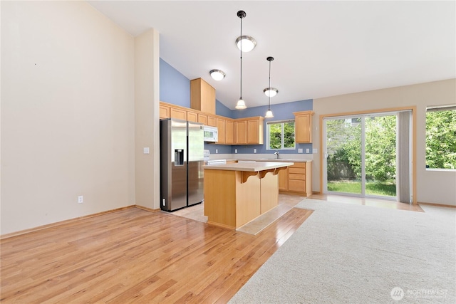 4254 Roxanna Loop SE, Lacey, WA 98503 - kitchen with stainless steel fridge, white microwave, light brown cabinets, light countertops, and light wood-type flooring