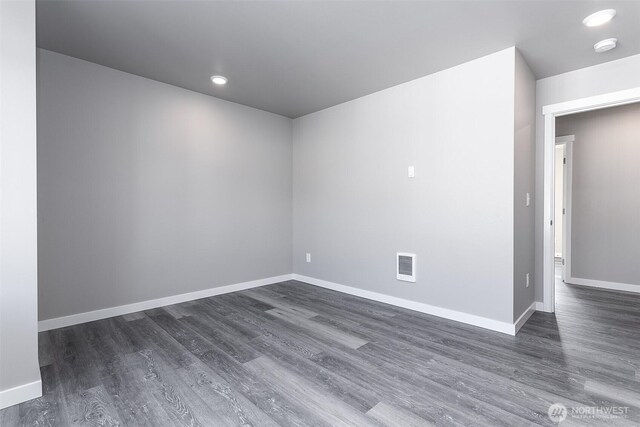 unfurnished room with recessed lighting, visible vents, baseboards, and dark wood-style flooring