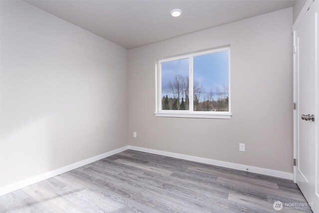 empty room with wood finished floors and baseboards