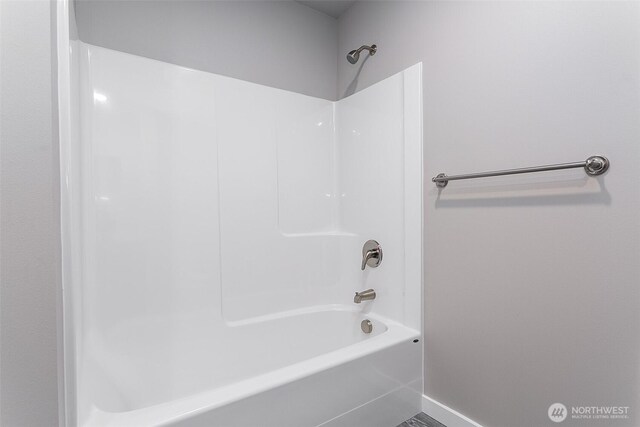 full bathroom featuring baseboards and shower / bathtub combination