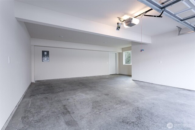 garage with electric panel and a garage door opener