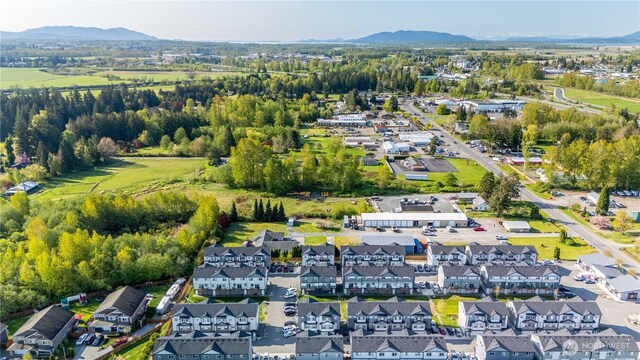 drone / aerial view featuring a residential view and a mountain view