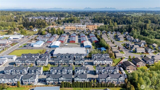 drone / aerial view with a forest view and a residential view