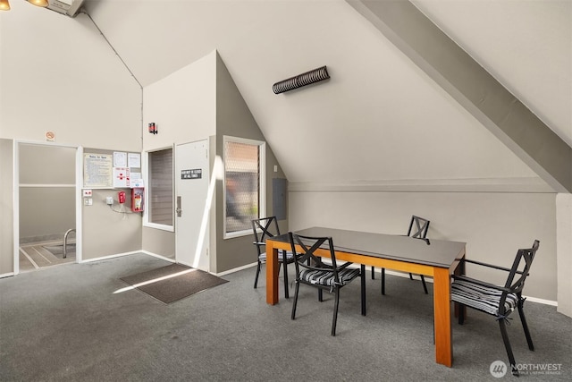 carpeted dining space with lofted ceiling and baseboards