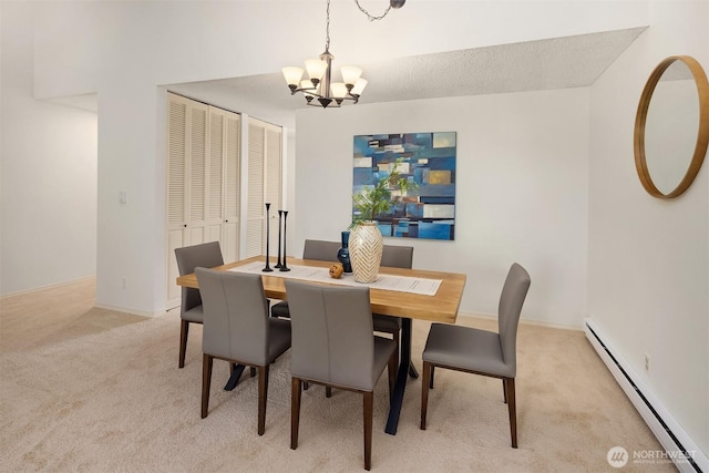 dining space featuring baseboard heating, a chandelier, and light colored carpet