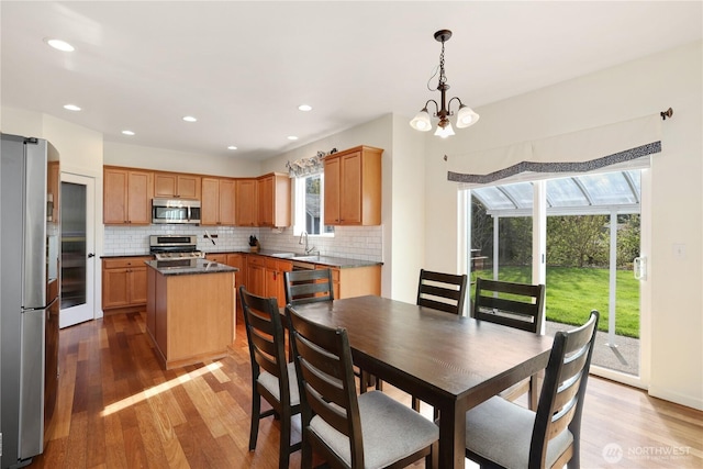 dining area featuring recessed lighting, a chandelier, and light wood finished floors