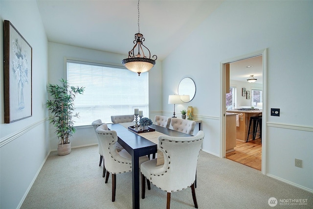 dining space with light colored carpet and a healthy amount of sunlight