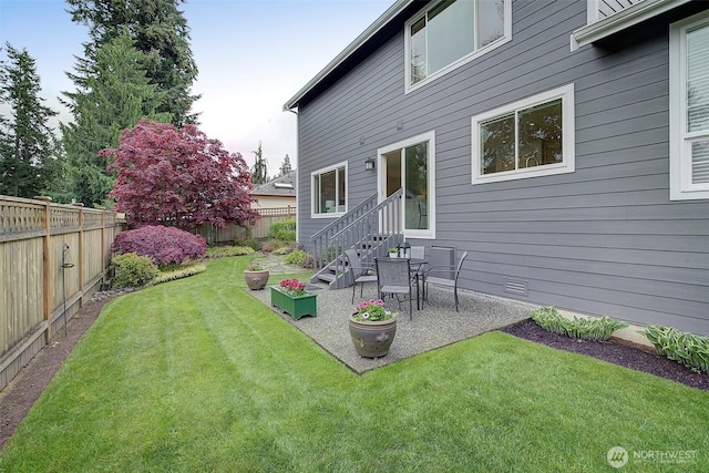 back of property featuring a patio, a fenced backyard, and a yard