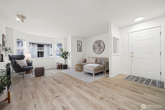 foyer with baseboards and wood finished floors