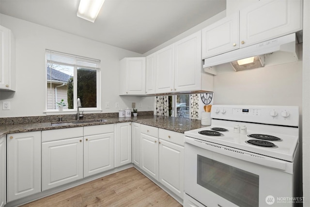 kitchen featuring white cabinets, under cabinet range hood, a sink, and white electric range