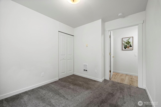 unfurnished bedroom with visible vents, baseboards, carpet floors, and a closet