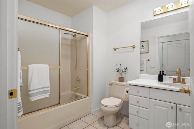 full bathroom featuring tile patterned flooring, vanity, enclosed tub / shower combo, and toilet