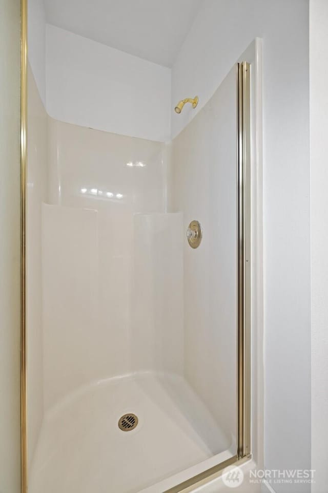 full bath featuring a shower stall
