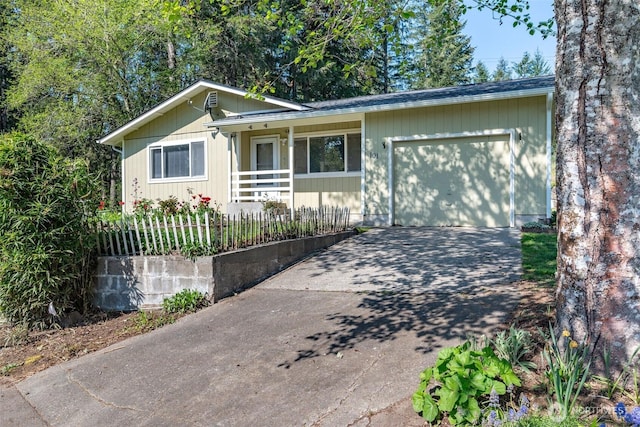 single story home featuring driveway, a porch, and an attached garage