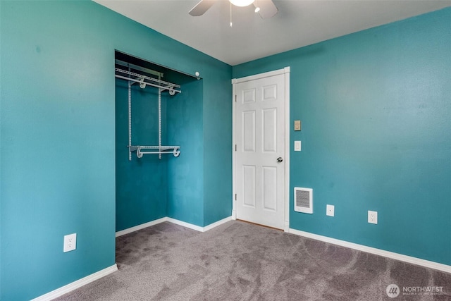 carpeted empty room with visible vents, ceiling fan, and baseboards