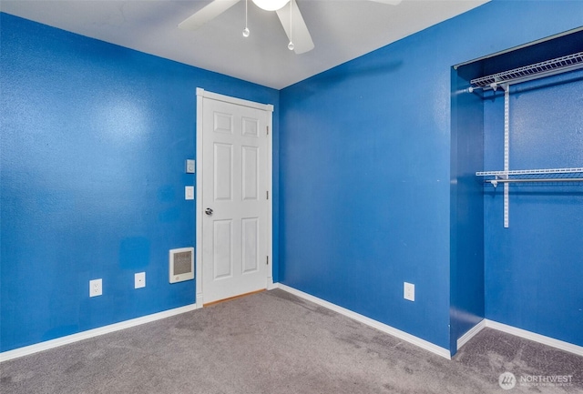 unfurnished room featuring carpet, ceiling fan, visible vents, and baseboards