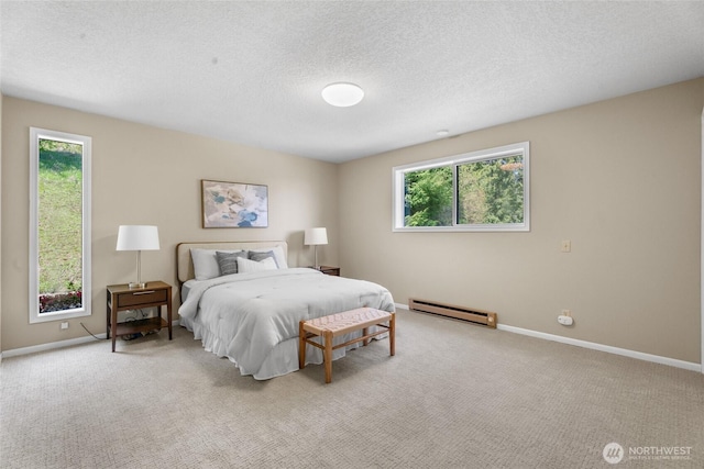 3837 Columbia Heights Rd, Longview, WA 98632 - carpeted bedroom with baseboards, a textured ceiling, a baseboard heating unit, and multiple windows