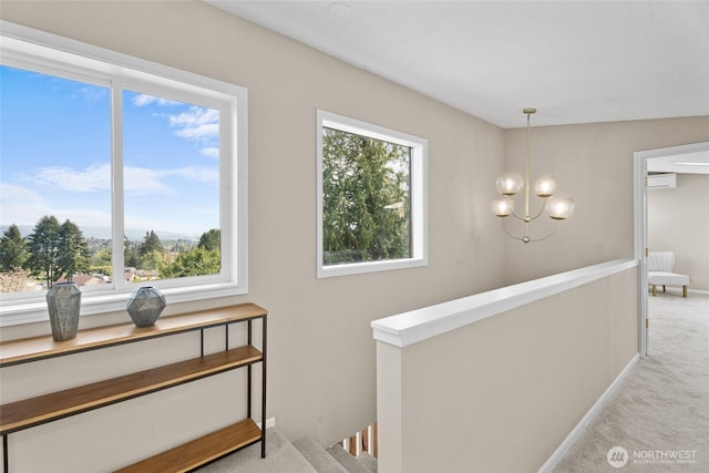 3837 Columbia Heights Rd, Longview, WA 98632 - staircase featuring an AC wall unit, carpet, baseboards, and a notable chandelier