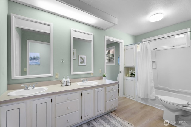 3837 Columbia Heights Rd, Longview, WA 98632 - full bathroom featuring toilet, a sink, shower / bath combo, and wood finished floors