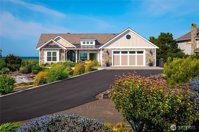 33 E Seashore Ln, Sequim, WA 98382 - craftsman house with aphalt driveway, stone siding, board and batten siding, and a garage