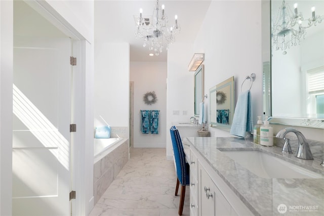 33 E Seashore Ln, Sequim, WA 98382 - full bath featuring marble finish floor, double vanity, a sink, a bath, and a notable chandelier