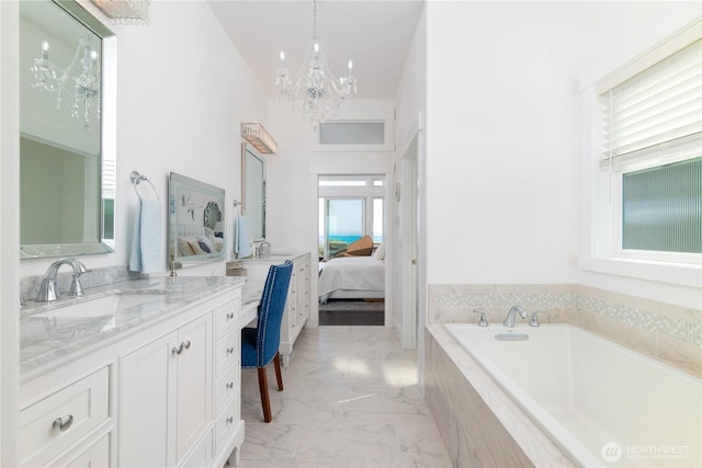 33 E Seashore Ln, Sequim, WA 98382 - full bath with marble finish floor, vanity, connected bathroom, a garden tub, and a notable chandelier