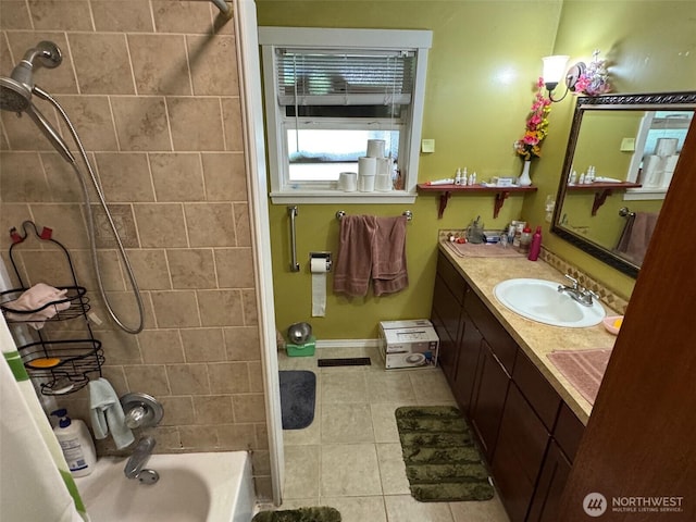 full bathroom featuring baseboards, vanity, tile patterned floors, and shower / bath combination