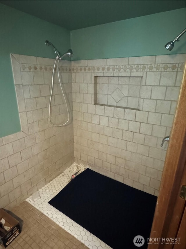 bathroom with a tile shower
