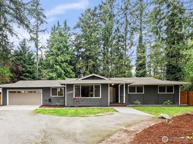12916 97th Ave NW, Gig Harbor, WA 98329 - ranch-style home featuring fence, an attached garage, a porch, a front yard, and driveway