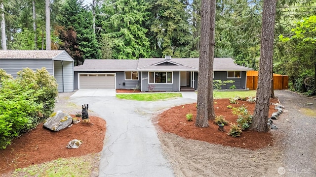 12916 97th Ave NW, Gig Harbor, WA 98329 - ranch-style home with fence, board and batten siding, an attached garage, driveway, and a porch