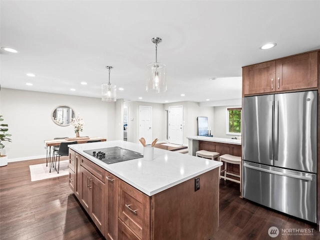 12916 97th Ave NW, Gig Harbor, WA 98329 - kitchen featuring freestanding refrigerator, a kitchen island, black electric stovetop, recessed lighting, and dark wood finished floors