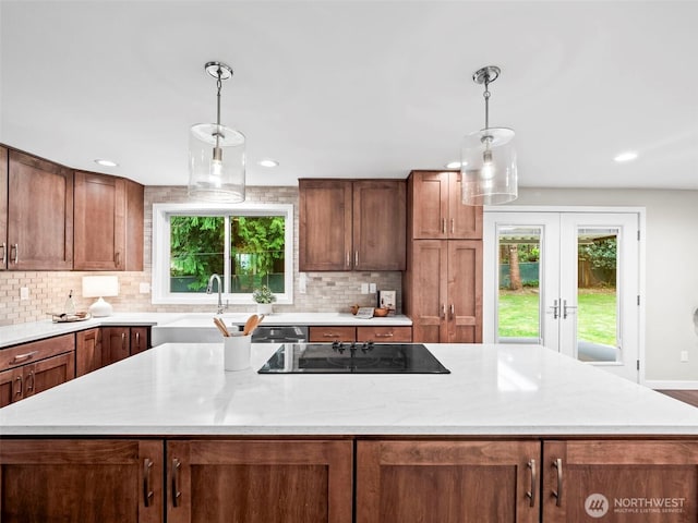12916 97th Ave NW, Gig Harbor, WA 98329 - kitchen with a sink, decorative backsplash, a kitchen island, and black electric cooktop