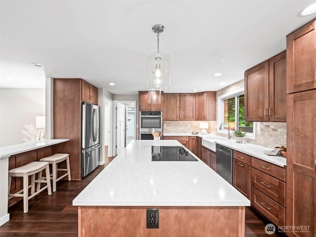 12916 97th Ave NW, Gig Harbor, WA 98329 - kitchen with decorative backsplash, a kitchen island, dark wood-style flooring, appliances with stainless steel finishes, and a sink