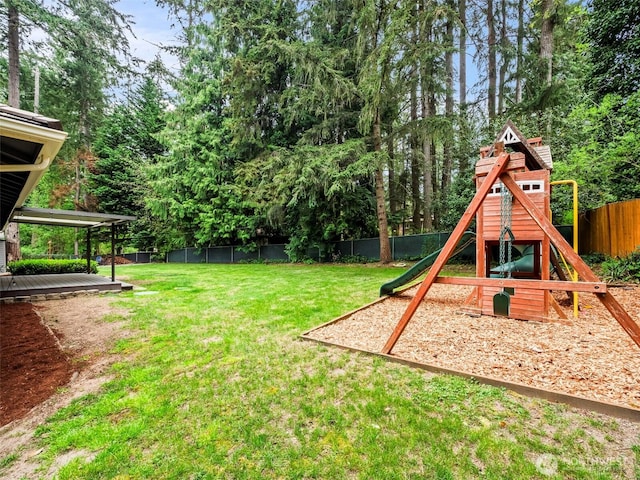 12916 97th Ave NW, Gig Harbor, WA 98329 - view of yard featuring a deck, a fenced backyard, and a playground