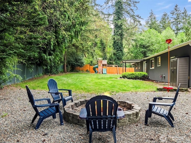 12916 97th Ave NW, Gig Harbor, WA 98329 - view of yard featuring a fenced backyard, a playground, and an outdoor fire pit