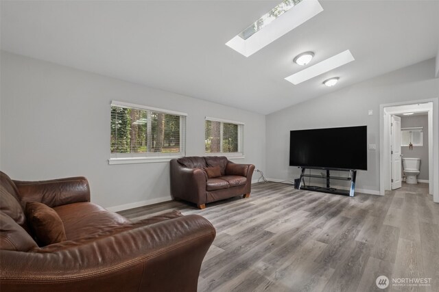 35622 4th Ave SW, Federal Way, WA 98023 - living room with baseboards, wood finished floors, and vaulted ceiling with skylight