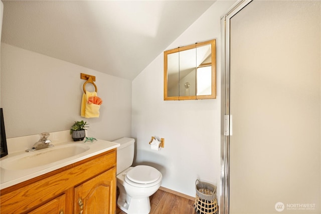 full bathroom with a shower with door, vaulted ceiling, wood finished floors, toilet, and vanity