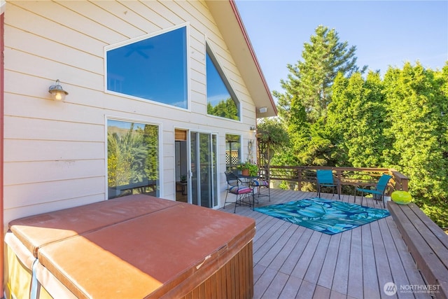 wooden deck with a covered hot tub
