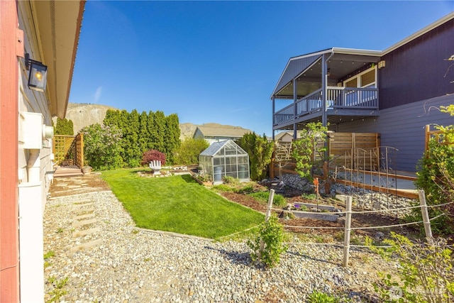 view of yard with an outdoor structure and a greenhouse