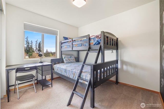 bedroom featuring carpet floors and baseboards