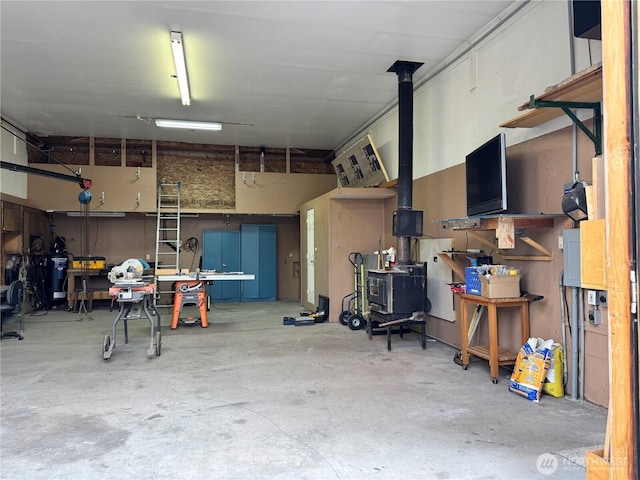 garage with a workshop area and a wood stove