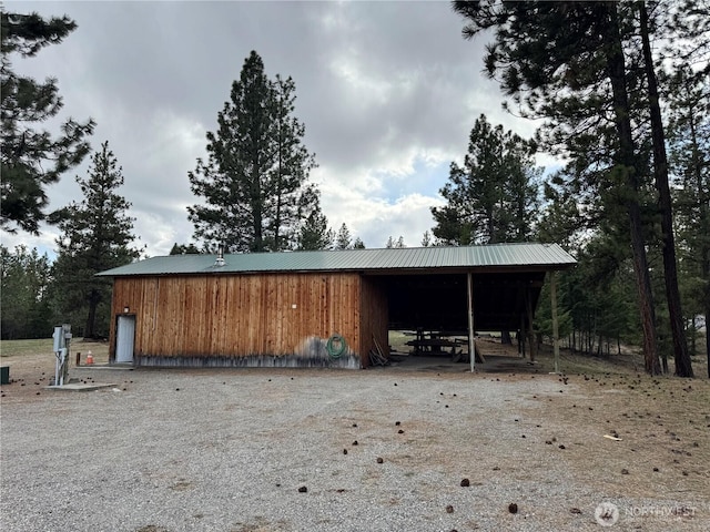 view of pole building featuring a carport and driveway