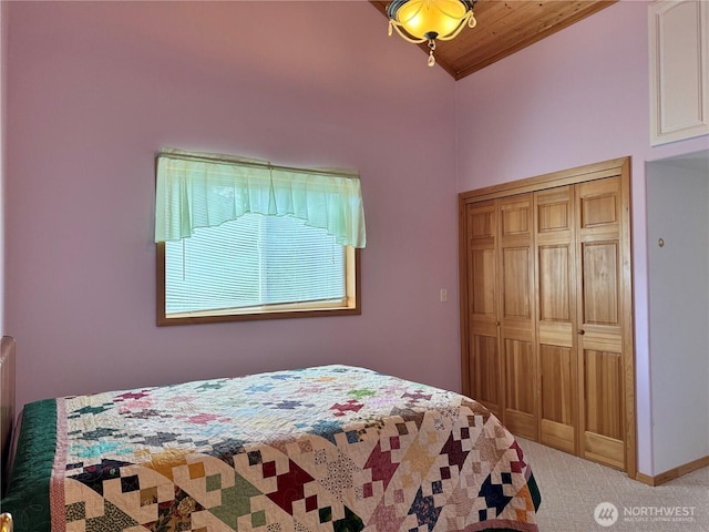 carpeted bedroom featuring lofted ceiling