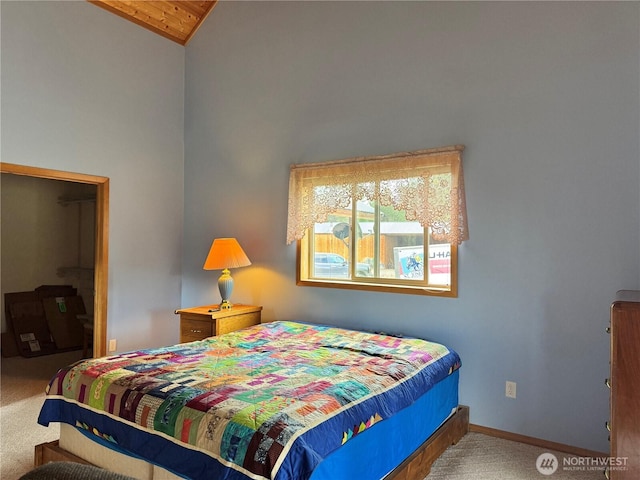 bedroom featuring carpet flooring, vaulted ceiling, and baseboards
