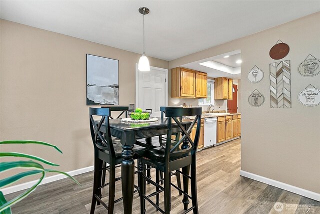 dining room featuring light wood-style floors and baseboards