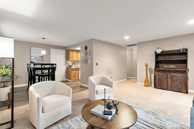living room with recessed lighting, baseboards, visible vents, and light carpet