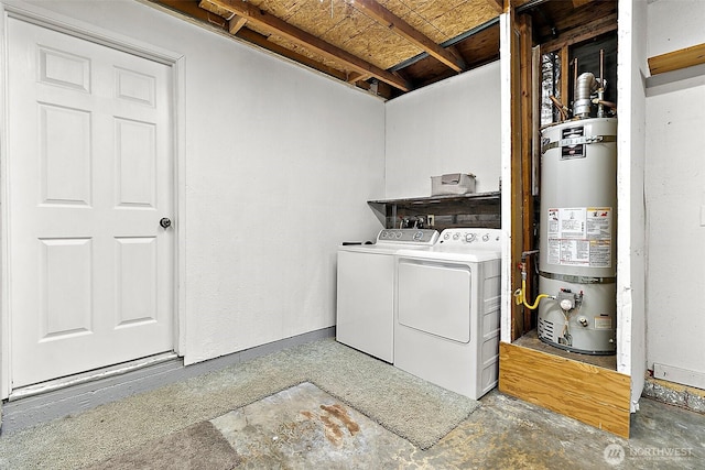 clothes washing area featuring separate washer and dryer, laundry area, and water heater