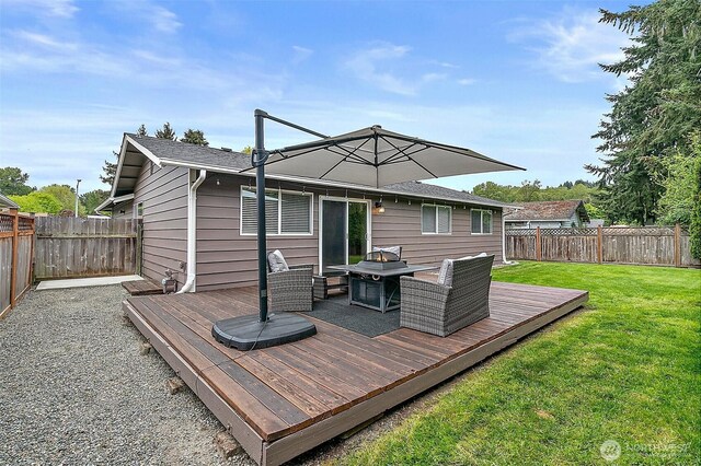 deck featuring a fenced backyard and a lawn