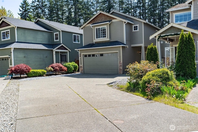 craftsman-style home featuring driveway, stone siding, and a garage