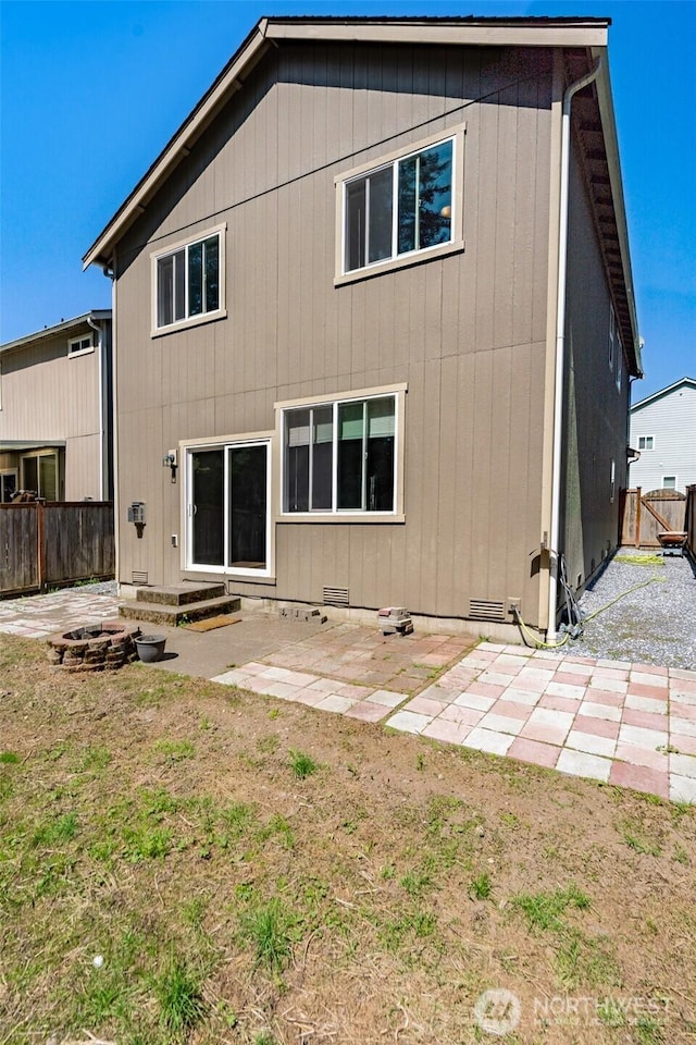 rear view of house featuring fence and a patio area